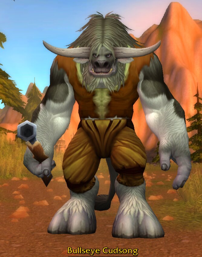 Bullseye Cudsong, a white and grey furred tauren with a pale shaggy mane and wide pale horns, wearing an orange-brown vest and baggy tan trousers and holding a small hex-headed hammer, standing on a dirt road in Mulgore with orange mesas behind him